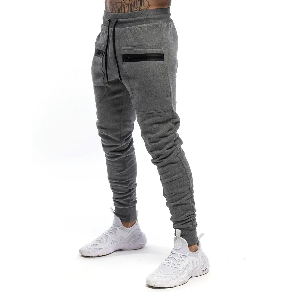 Calça Moletom Fitness Masculina Marcanzzi MZ315 em algodão premium, com cintura ajustável, bolsos com zíper e design moderno para treinos e casual.
