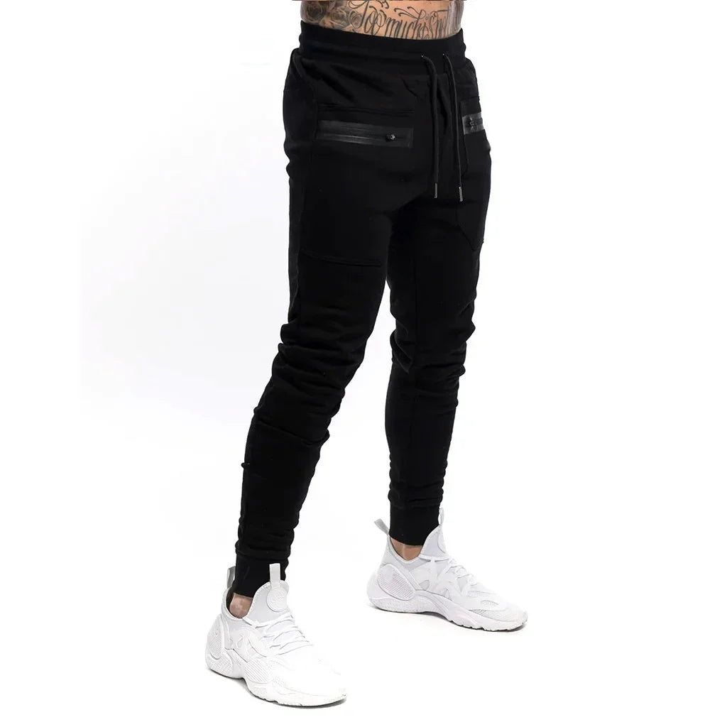 Calça Moletom Fitness Masculina Marcanzzi MZ315 em algodão premium, com cintura ajustável, bolsos com zíper e design moderno para treinos e casual.