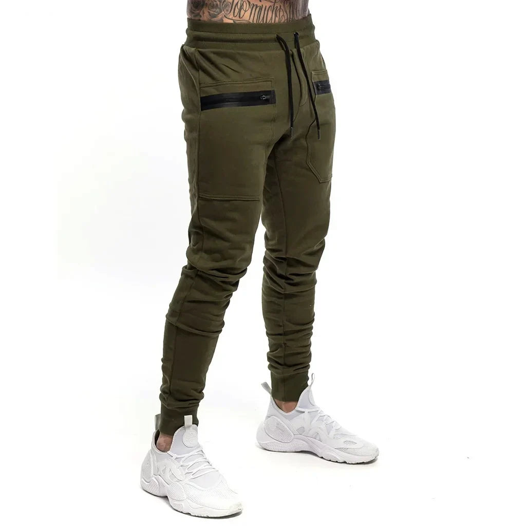 Calça Moletom Fitness Masculina Marcanzzi MZ315 em algodão premium, com cintura ajustável, bolsos com zíper e design moderno para treinos e casual.