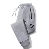 Calça Moletom Esportiva Masculina Marcanzzi MZ314 feita em algodão premium, com listras laterais, bolsos com zíper e cós ajustável para esportes.